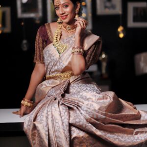 Elegant bride in custom-stitched saree blouse with aari work and traditional bridal jewelry